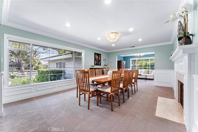 2618 N Louise St, Santa Ana, CA 92706 - carpeted dining room with recessed lighting, a chandelier, a decorative wall, crown molding, and a fireplace with flush hearth