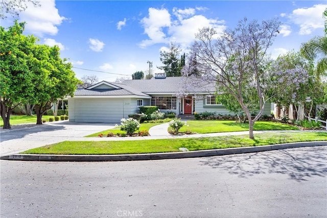2618 N Louise St, Santa Ana, CA 92706 - ranch-style home featuring concrete driveway, an attached garage, and a front lawn