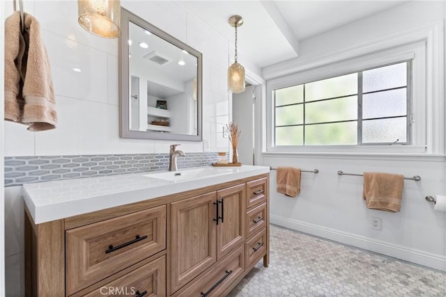 2618 N Louise St, Santa Ana, CA 92706 - bathroom featuring decorative backsplash, vanity, and baseboards