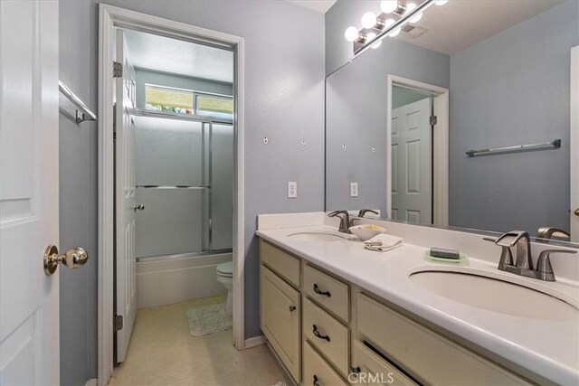 28335 Arroyo Ct, Castaic, CA 91384 - full bathroom featuring toilet, double vanity, and enclosed tub / shower combo