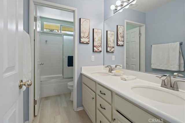 28335 Arroyo Ct, Castaic, CA 91384 - full bathroom featuring wood finished floors, toilet, double vanity, and shower / bath combination with glass door