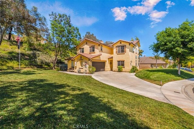 28335 Arroyo Ct, Castaic, CA 91384 - mediterranean / spanish-style house featuring stucco siding, driveway, a garage, and a front yard