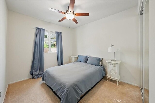 29661 Cambridge Ave, Castaic, CA 91384 - bedroom with light carpet, baseboards, and ceiling fan