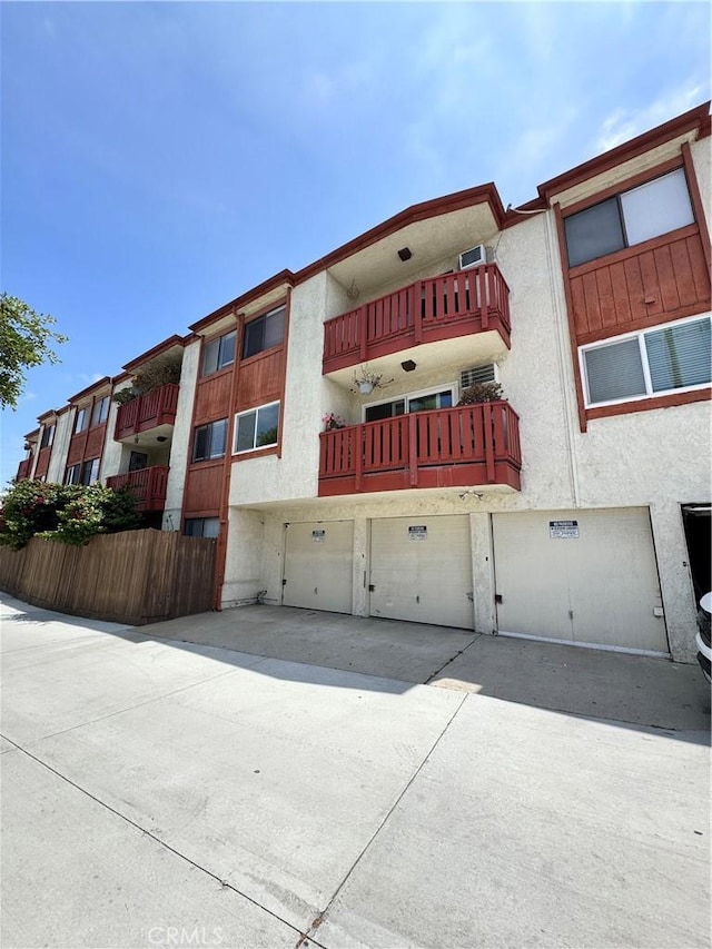 4591 Orange Ave Unit 306, Long Beach, CA 90807 - view of property featuring driveway and a garage