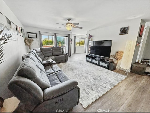 4591 Orange Ave Unit 306, Long Beach, CA 90807 - living room featuring ceiling fan, wood finished floors, and baseboards