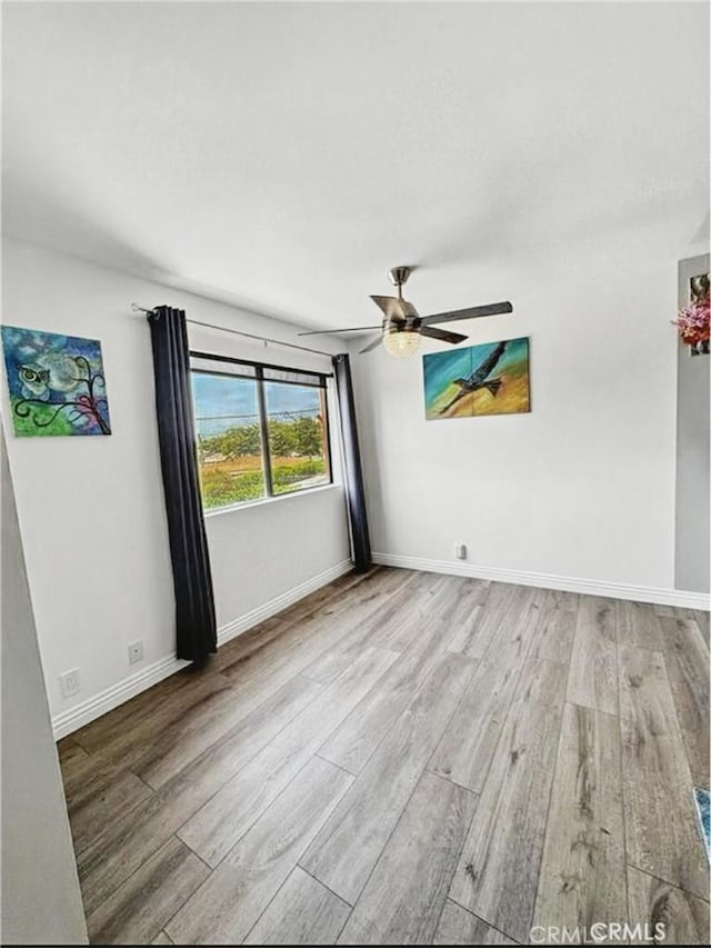 4591 Orange Ave Unit 306, Long Beach, CA 90807 - empty room with wood finished floors, a ceiling fan, and baseboards