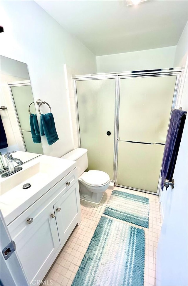 4591 Orange Ave Unit 306, Long Beach, CA 90807 - bathroom with vanity, toilet, a stall shower, and tile patterned floors