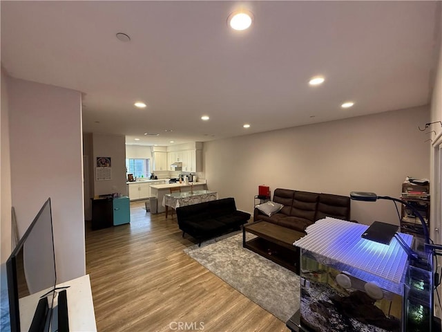 living room with recessed lighting and light wood-type flooring