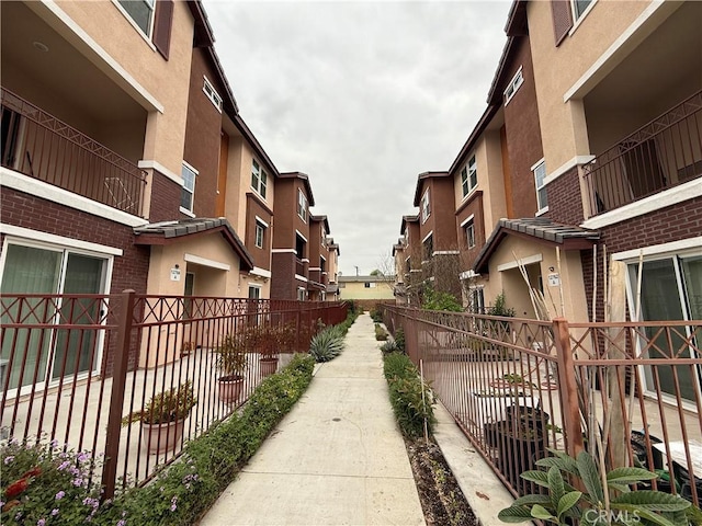view of home's community featuring fence and a residential view