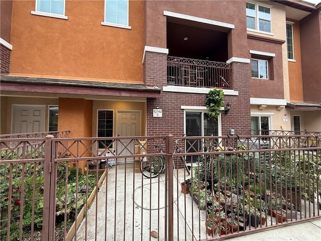 view of front of house with stucco siding and brick siding