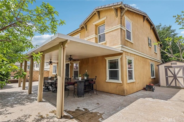 7055 Springtime Ave, Fontana, CA 92336 - rear view of property featuring ceiling fan, outdoor dining area, stucco siding, and a patio area