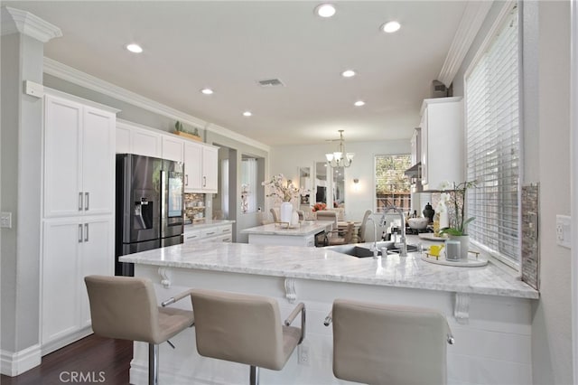 4885 Dandelion, Tracy, CA 95377 - kitchen with stainless steel fridge with ice dispenser, a peninsula, a sink, white cabinetry, and recessed lighting