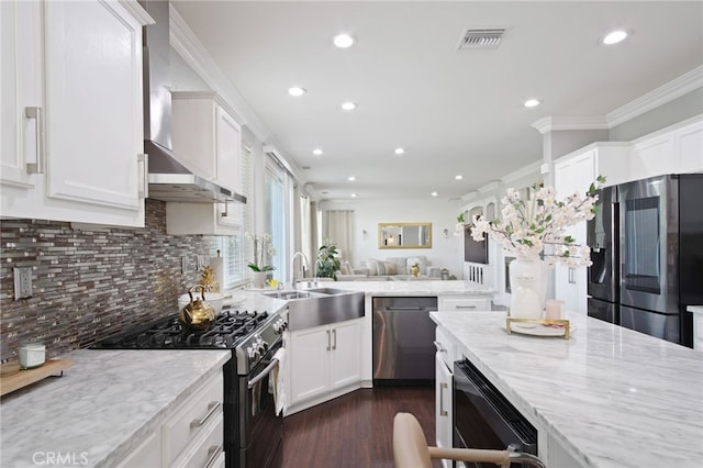 4885 Dandelion, Tracy, CA 95377 - kitchen featuring stainless steel appliances, a sink, wall chimney range hood, recessed lighting, and white cabinets