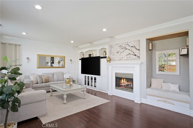 4885 Dandelion, Tracy, CA 95377 - living room with dark wood finished floors, recessed lighting, crown molding, and a glass covered fireplace