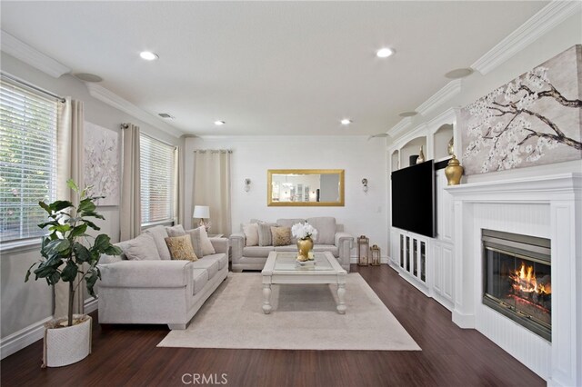4885 Dandelion, Tracy, CA 95377 - living room featuring dark wood finished floors, recessed lighting, ornamental molding, a glass covered fireplace, and baseboards