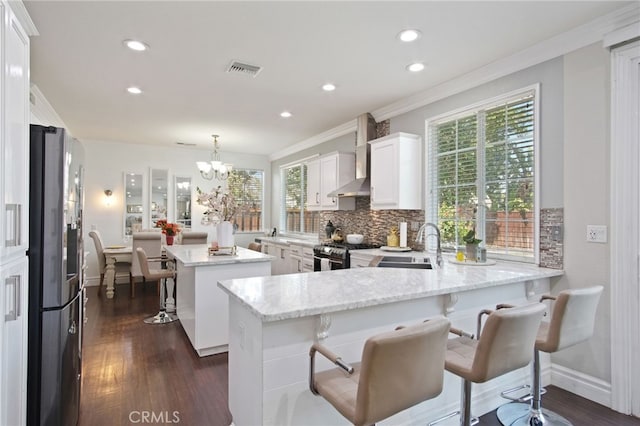 4885 Dandelion, Tracy, CA 95377 - kitchen with stainless steel appliances, wall chimney exhaust hood, a sink, ornamental molding, and tasteful backsplash