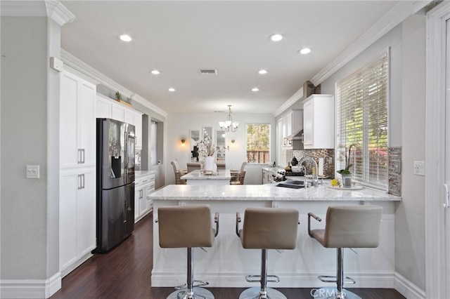 4885 Dandelion, Tracy, CA 95377 - kitchen featuring stainless steel refrigerator with ice dispenser, white cabinets, dark wood-type flooring, recessed lighting, and a peninsula