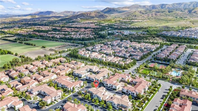 aerial view of property's location with nearby suburban area and a mountain backdrop