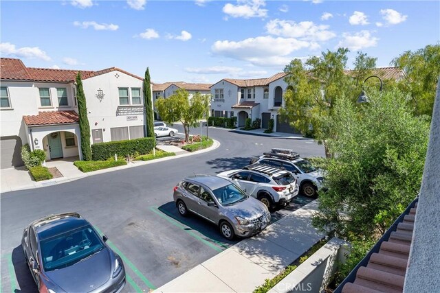 uncovered parking lot featuring a residential view