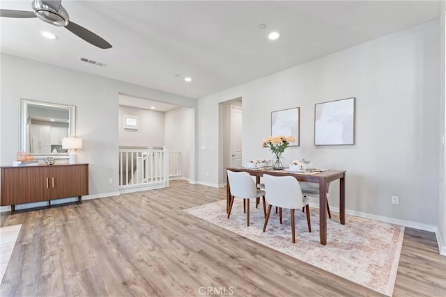 dining room featuring light wood finished floors, ceiling fan, baseboards, and recessed lighting