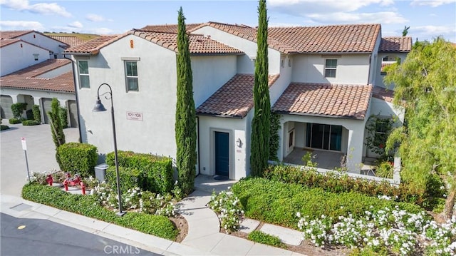 mediterranean / spanish house with a tile roof and stucco siding