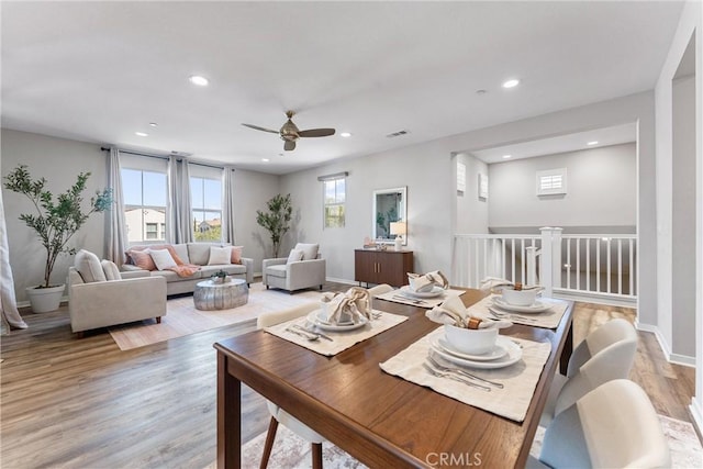 dining room featuring a ceiling fan, light wood-type flooring, recessed lighting, and baseboards
