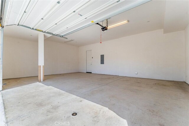 garage featuring electric panel and a garage door opener