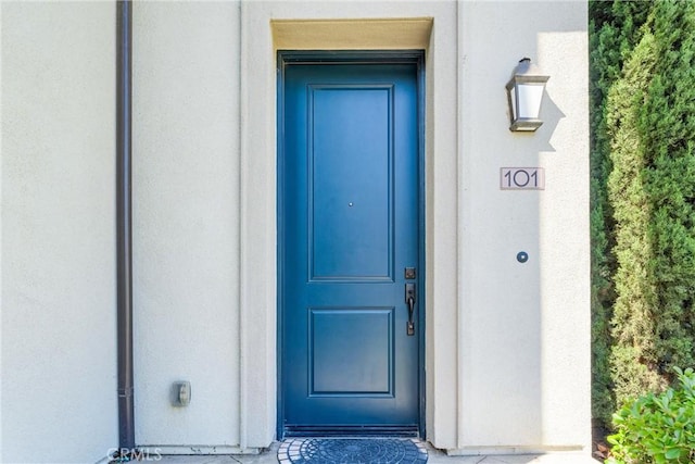 doorway to property with stucco siding