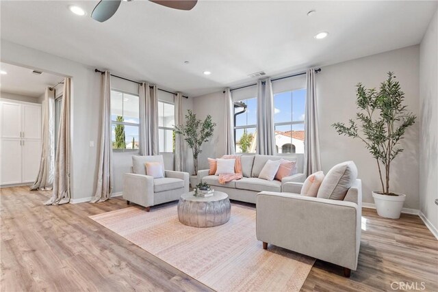 living room with light wood-style flooring, recessed lighting, baseboards, and ceiling fan
