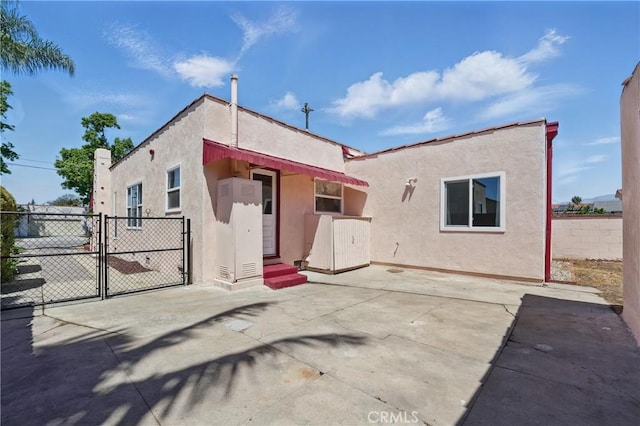 832 S 7th St, Alhambra, CA 91801 - rear view of property with stucco siding, fence, a gate, and a patio