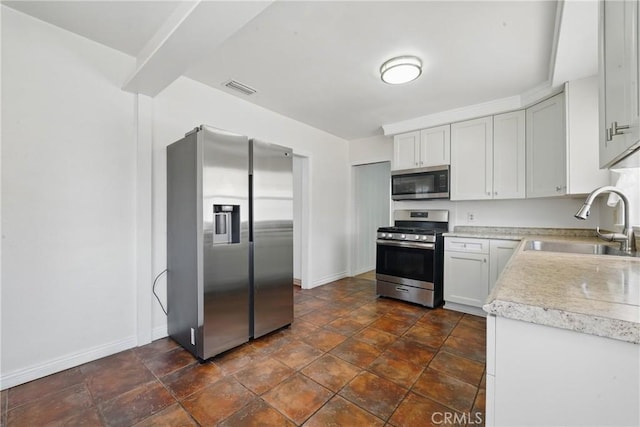 832 S 7th St, Alhambra, CA 91801 - kitchen featuring appliances with stainless steel finishes, a sink, baseboards, and light countertops