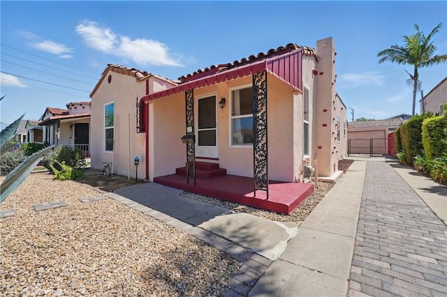 832 S 7th St, Alhambra, CA 91801 - view of front facade featuring stucco siding, a tile roof, and fence