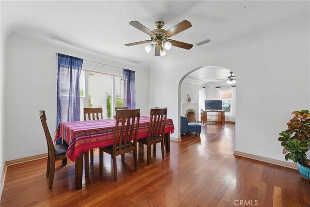 832 S 7th St, Alhambra, CA 91801 - dining space featuring arched walkways, ceiling fan, wood finished floors, and baseboards