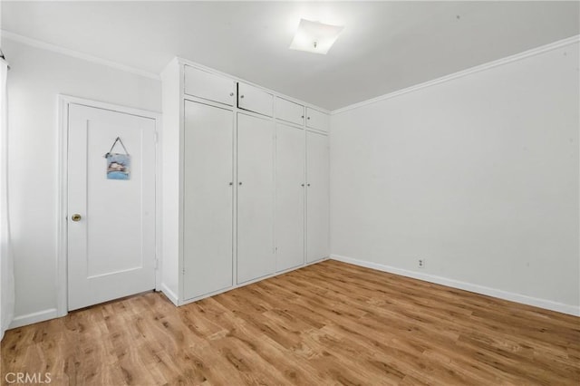 832 S 7th St, Alhambra, CA 91801 - unfurnished bedroom with crown molding, light wood-style floors, baseboards, and a closet