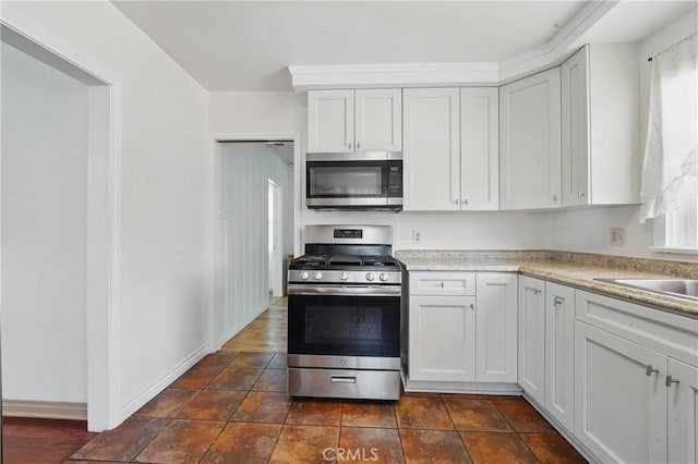 832 S 7th St, Alhambra, CA 91801 - kitchen with appliances with stainless steel finishes, white cabinetry, baseboards, and light stone countertops
