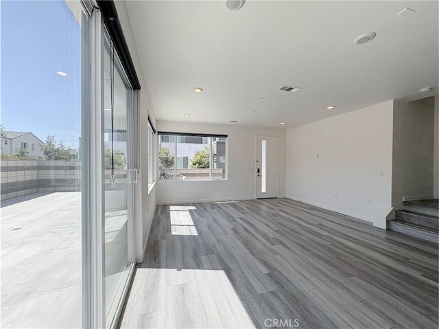 3661 S Allston Paseo Unit 7, Ontario, CA 91761 - unfurnished living room featuring wood finished floors, baseboards, and recessed lighting