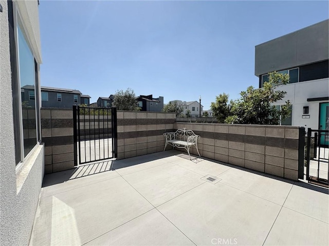 3661 S Allston Paseo Unit 7, Ontario, CA 91761 - view of patio / terrace featuring a gate and a residential view