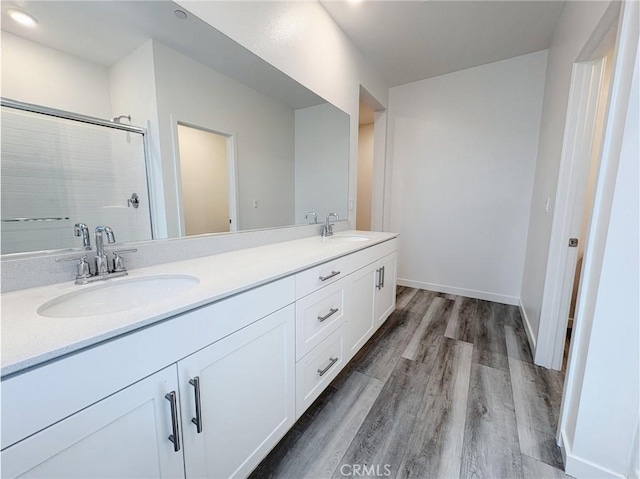 3661 S Allston Paseo Unit 7, Ontario, CA 91761 - full bath with wood finished floors, double vanity, a shower with shower door, and baseboards