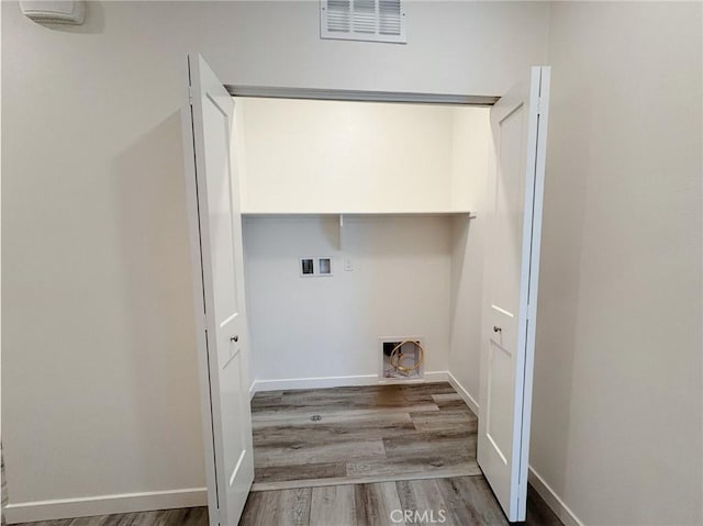 3661 S Allston Paseo Unit 7, Ontario, CA 91761 - laundry area featuring washer hookup, wood finished floors, and baseboards