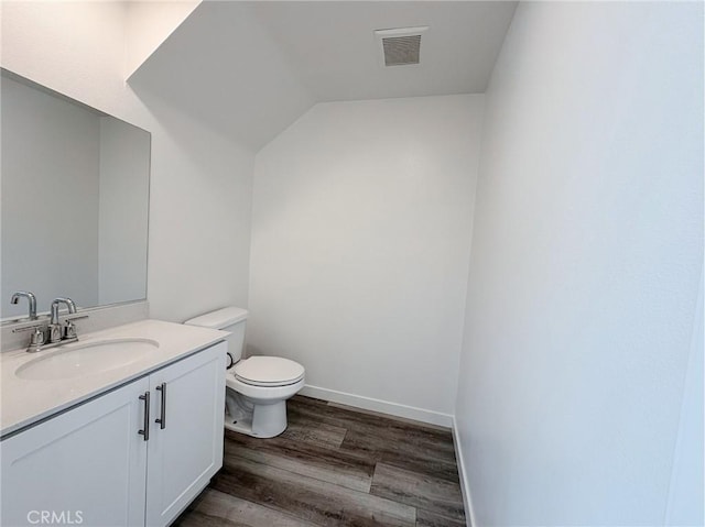 3661 S Allston Paseo Unit 7, Ontario, CA 91761 - bathroom with toilet, vanity, wood finished floors, baseboards, and vaulted ceiling