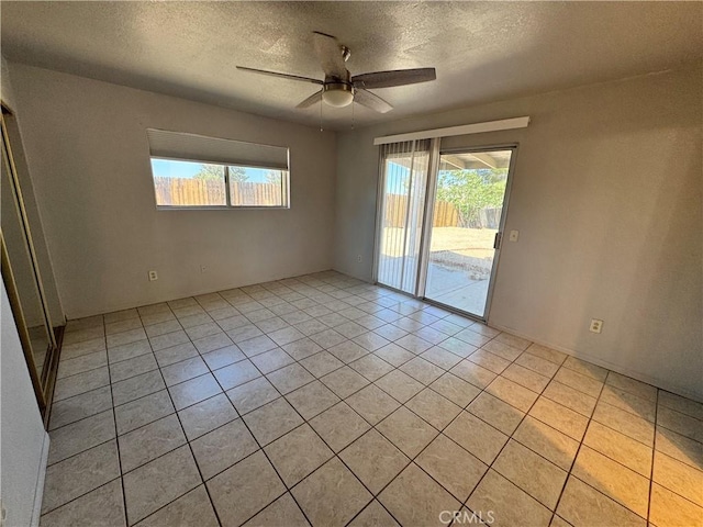 8723 Palomar Ave, Yucca Valley, CA 92284 - spare room with a textured ceiling, a ceiling fan, and light tile patterned floors