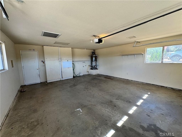 8723 Palomar Ave, Yucca Valley, CA 92284 - garage featuring a garage door opener and secured water heater