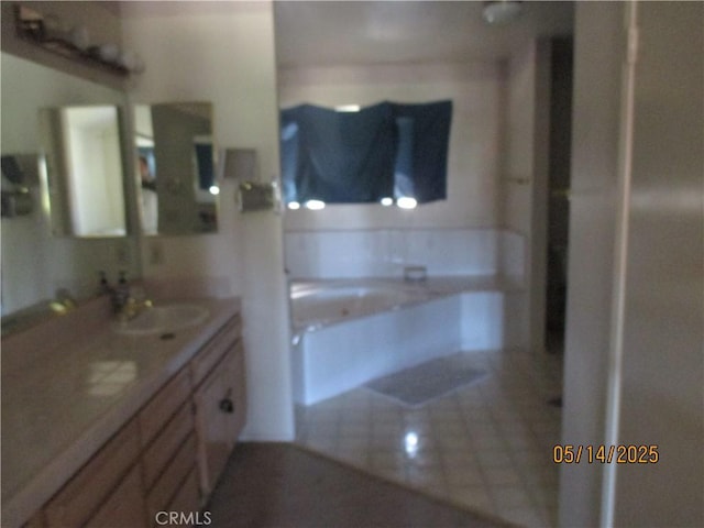 full bath featuring vanity and a bath