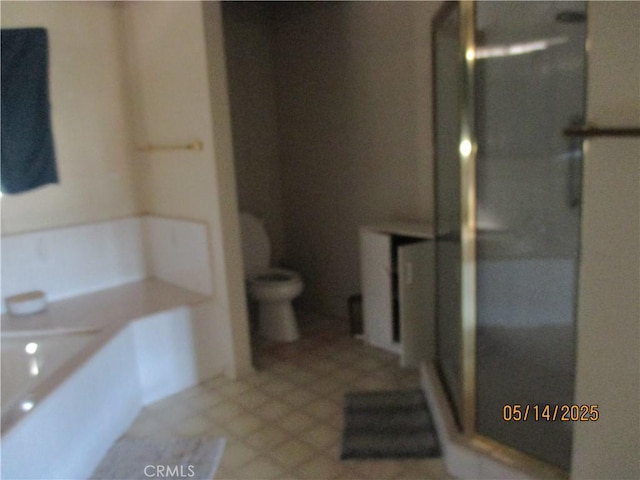 full bathroom featuring a stall shower, toilet, and tile patterned flooring