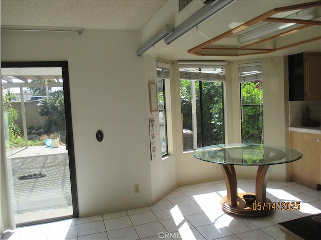 doorway to outside featuring healthy amount of natural light and light tile patterned floors