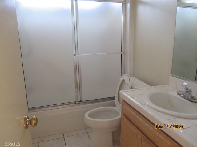 bathroom with toilet, enclosed tub / shower combo, and vanity