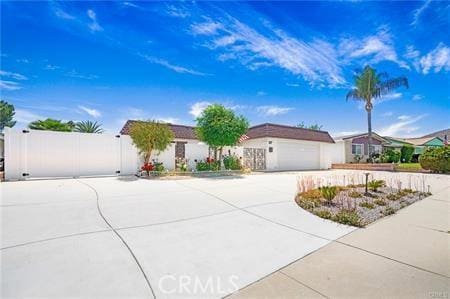 25813 Sandy Lodge Rd, Menifee, CA 92586 - ranch-style house with concrete driveway, a garage, and a gate