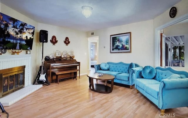 25813 Sandy Lodge Rd, Menifee, CA 92586 - living room featuring wood finished floors and a brick fireplace