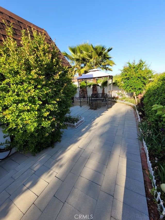 25813 Sandy Lodge Rd, Menifee, CA 92586 - view of patio with a gazebo, outdoor dining area, and fence