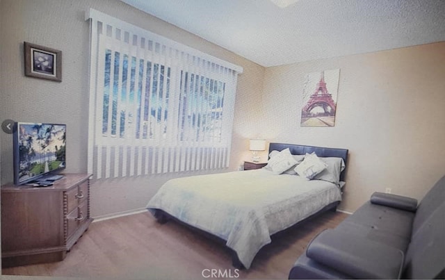 25813 Sandy Lodge Rd, Menifee, CA 92586 - bedroom featuring a textured ceiling, baseboards, and wood finished floors